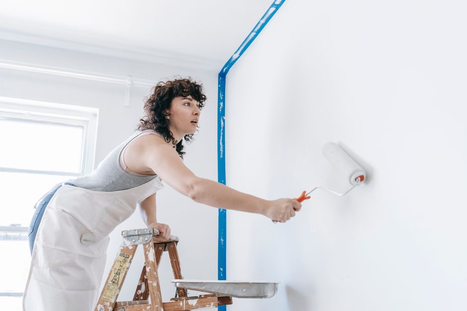Painter working on a house